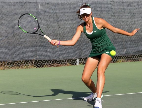 Tomi Main playing tennis at Robert Louis Stevenson High School in green uniform